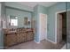 Bathroom featuring double sinks with granite countertops and a stylish vanity at 8765 W Custer Ln, Peoria, AZ 85381