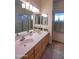 Bathroom with a long double sink vanity with a view of the shower at 8765 W Custer Ln, Peoria, AZ 85381