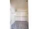A walk-in closet is shown with multiple shelves and carpeted floors at 8765 W Custer Ln, Peoria, AZ 85381
