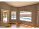 Dining space with hardwood floors and windows overlooking the sparkling pool at 8765 W Custer Ln, Peoria, AZ 85381