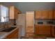 Well-lit kitchen showing a stainless steel sink, oak-finish cabinets, and laminate countertops at 8765 W Custer Ln, Peoria, AZ 85381