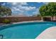 Private backyard pool surrounded by mature trees, providing a serene oasis at 8765 W Custer Ln, Peoria, AZ 85381