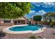 Backyard with a sparkling pool, mature trees and patio at 8765 W Custer Ln, Peoria, AZ 85381