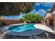 Backyard featuring a sparkling blue pool surrounded by mature trees at 8765 W Custer Ln, Peoria, AZ 85381