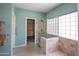 Spa-like bathroom with glass shower, tiled walls, and walk-in closet access at 8765 W Custer Ln, Peoria, AZ 85381