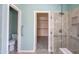 Bathroom featuring a glass-enclosed shower and a walk-in closet at 8765 W Custer Ln, Peoria, AZ 85381