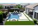 Aerial view of backyard oasis featuring a pool, spa, pergola, and lush landscaping at 10520 E Thorite Cir, Mesa, AZ 85212