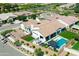 Stunning aerial view of a home with a backyard oasis featuring a pool, spa, outdoor kitchen and seating area at 10520 E Thorite Cir, Mesa, AZ 85212