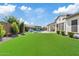 Expansive backyard featuring manicured lawn and luxurious pool with outdoor seating at 10520 E Thorite Cir, Mesa, AZ 85212