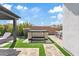 Inviting backyard featuring a pergola, artificial turf and a hot tub at 10520 E Thorite Cir, Mesa, AZ 85212