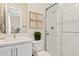 Bright bathroom with white tile shower, quartz countertops, and tasteful botanical wall decor at 10520 E Thorite Cir, Mesa, AZ 85212