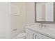 A well-lit half bathroom features a white vanity with modern fixtures and simple decor at 10520 E Thorite Cir, Mesa, AZ 85212