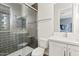 Modern bathroom featuring a tiled shower with glass door and vanity with white cabinets at 10520 E Thorite Cir, Mesa, AZ 85212