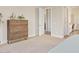Bedroom view featuring a dresser, open door, and view of the adjacent bathroom at 10520 E Thorite Cir, Mesa, AZ 85212