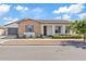 Charming single-story home with brick and stucco exterior, well-maintained landscaping, and a two-car garage at 10520 E Thorite Cir, Mesa, AZ 85212