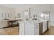 Open-concept kitchen with a marble-top island, stainless steel appliances, and cozy breakfast bar at 10520 E Thorite Cir, Mesa, AZ 85212