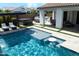 Beautiful pool with built-in bar, a hot tub, and covered seating area, perfect for outdoor entertaining at 10520 E Thorite Cir, Mesa, AZ 85212