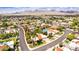 Expansive aerial view of a suburban neighborhood with lush greenery and mountain backdrop under a bright blue sky at 10658 E Cinnabar Ave, Scottsdale, AZ 85258