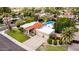 Expansive property with a red tile roof, lush landscaping, a private pool, and a two-car garage at 10658 E Cinnabar Ave, Scottsdale, AZ 85258