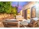 Cozy backyard patio with comfortable seating, well manicured trees, and a private spot for enjoying the outdoors at 10658 E Cinnabar Ave, Scottsdale, AZ 85258