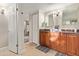 Traditional bathroom with dual vanity, wood cabinets and tiled floor at 10658 E Cinnabar Ave, Scottsdale, AZ 85258