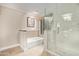 Bathroom featuring a glass enclosed shower, soaking tub, and tiled floors at 10658 E Cinnabar Ave, Scottsdale, AZ 85258