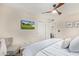Comfortable bedroom with a ceiling fan, TV, and carpeted floors at 10658 E Cinnabar Ave, Scottsdale, AZ 85258