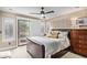 Comfortable bedroom with a leather bed, outside patio, and neutral decor at 10658 E Cinnabar Ave, Scottsdale, AZ 85258