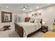 Bedroom featuring a ceiling fan, window with shutters, and a wooden bedframe at 10658 E Cinnabar Ave, Scottsdale, AZ 85258