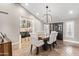 Elegant dining room showcases a wooden table, seating for six, and a glass enclosed wine storage at 10658 E Cinnabar Ave, Scottsdale, AZ 85258