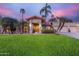 Beautiful front yard with lush green grass, mature trees, and a welcoming entrance at 10658 E Cinnabar Ave, Scottsdale, AZ 85258