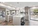 Bright and modern kitchen includes an island with seating and views of the backyard at 10658 E Cinnabar Ave, Scottsdale, AZ 85258