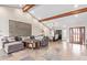 Spacious living room with vaulted ceilings, wood beams, tile flooring, and modern decor at 10658 E Cinnabar Ave, Scottsdale, AZ 85258