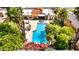 Aerial view showcasing a sparkling pool and outdoor dining, shaded by mature palm trees, and lush landscape at 10658 E Cinnabar Ave, Scottsdale, AZ 85258