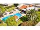 Aerial view of a refreshing swimming pool with lounge chairs, a gazebo, and mature trees for shade at 10658 E Cinnabar Ave, Scottsdale, AZ 85258