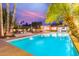 Inviting pool and patio area with palm trees and outdoor seating, perfect for relaxation at 10658 E Cinnabar Ave, Scottsdale, AZ 85258
