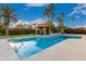 Gorgeous swimming pool with travertine surround, cabana, waterfall feature, and lush tropical landscaping at 10658 E Cinnabar Ave, Scottsdale, AZ 85258
