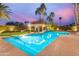 Luxurious pool area with a gazebo, palm trees, lush landscaping, and clear blue water for relaxation and enjoyment at 10658 E Cinnabar Ave, Scottsdale, AZ 85258