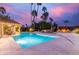 Beautiful backyard oasis with a swimming pool, gazebo, lounge chairs, a fire pit, and lush landscaping for outdoor living at 10658 E Cinnabar Ave, Scottsdale, AZ 85258