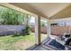 Relaxing covered patio with a view of the green backyard and privacy wall at 12107 N 66Th Ave, Glendale, AZ 85304
