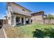 Backyard features a covered patio and well-maintained lawn, ideal for outdoor activities at 12107 N 66Th Ave, Glendale, AZ 85304