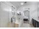 Well-lit bathroom with a tub, and a shower. A bedroom is visible through the doorway at 12107 N 66Th Ave, Glendale, AZ 85304