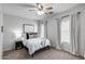 Bright bedroom with a comfy bed, neutral carpet, and natural light from the window at 12107 N 66Th Ave, Glendale, AZ 85304