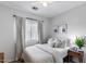 Cozy bedroom features a plush bed, side table, and natural light from the window at 12107 N 66Th Ave, Glendale, AZ 85304