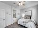 Bright bedroom features a ceiling fan and ensuite bathroom with a tub and shower at 12107 N 66Th Ave, Glendale, AZ 85304