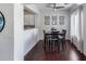 Charming dining area features dark wood table set and curated photo gallery wall at 12107 N 66Th Ave, Glendale, AZ 85304
