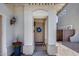 Charming front entryway featuring a decorative wreath and plants creating a warm, inviting atmosphere at 12107 N 66Th Ave, Glendale, AZ 85304