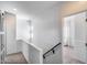 Hallway features neutral carpet, white walls, and a charming sliding barn door to a bedroom at 12107 N 66Th Ave, Glendale, AZ 85304