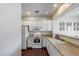 Efficient kitchen design featuring white appliances and a view to the dining area at 12107 N 66Th Ave, Glendale, AZ 85304