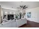 Inviting living room showcases a stylish sectional, dark hardwood floors, and minimalist decor, offering a comfortable atmosphere at 12107 N 66Th Ave, Glendale, AZ 85304